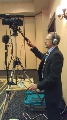 Executive Producer, Peter Stassa, filming with headphones on to monitor audio.