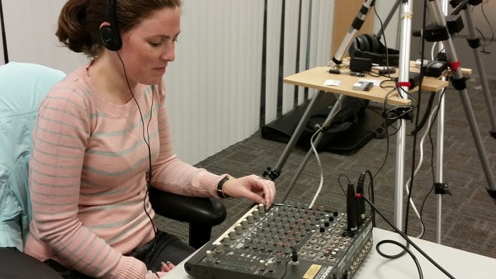 Lead Editor and Creative Director, Candice Moore, monitoring audio at a shoot for SimpliVity's employee orientation
