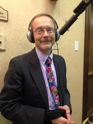 Executive Producer, Peter Stassa, standing at the camera with headphones on